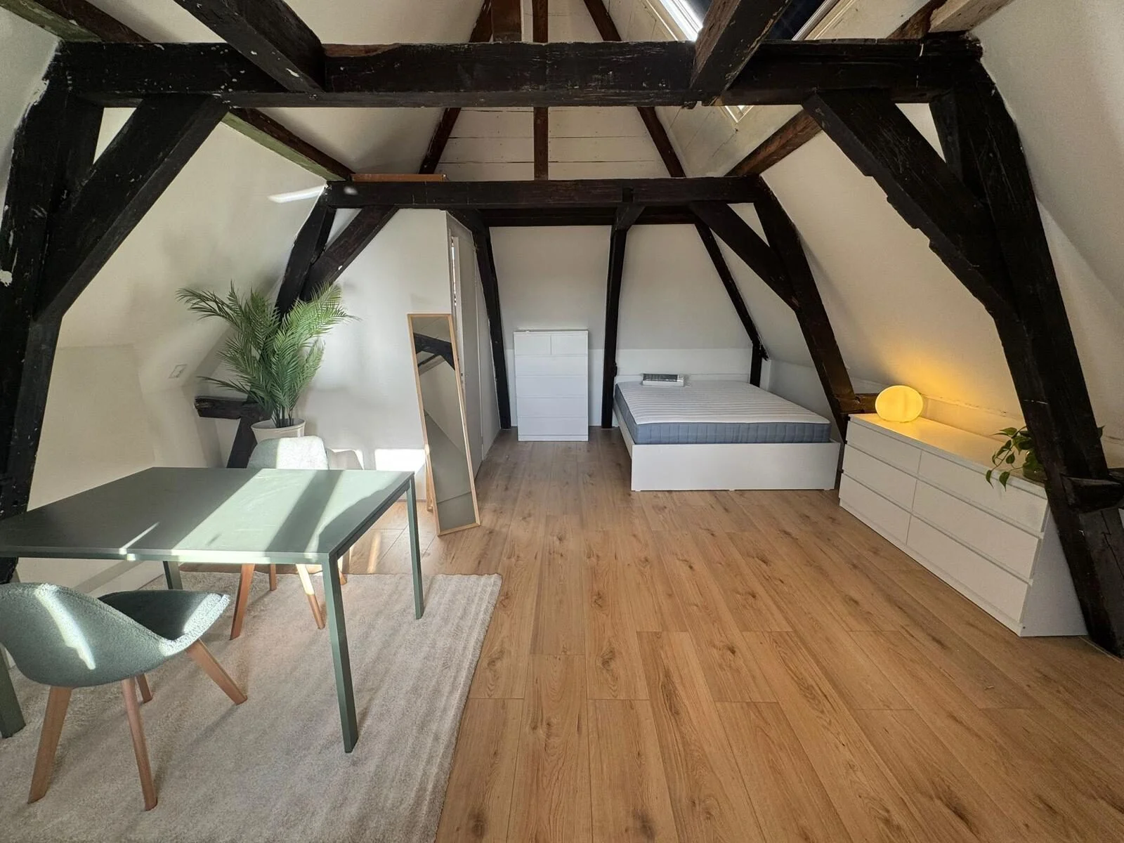 Loft living area with skylight and original beams